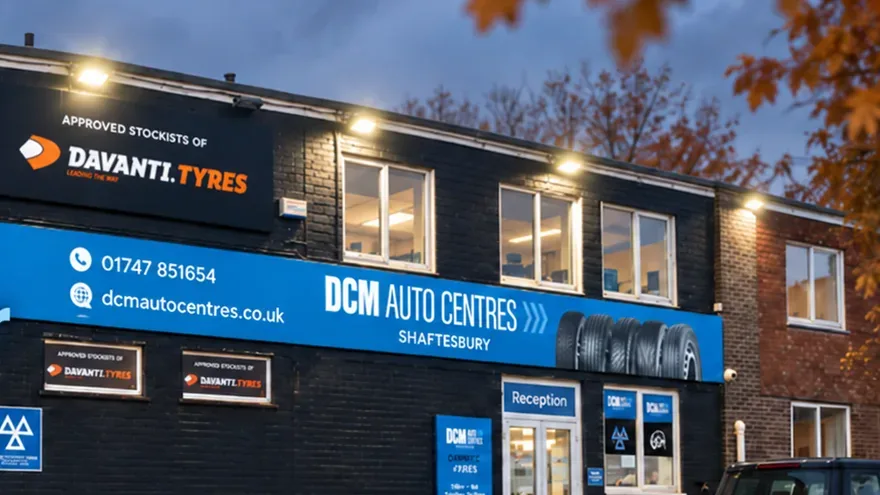 DCM Autocentres Shaftesbury lit up on an autumn evening